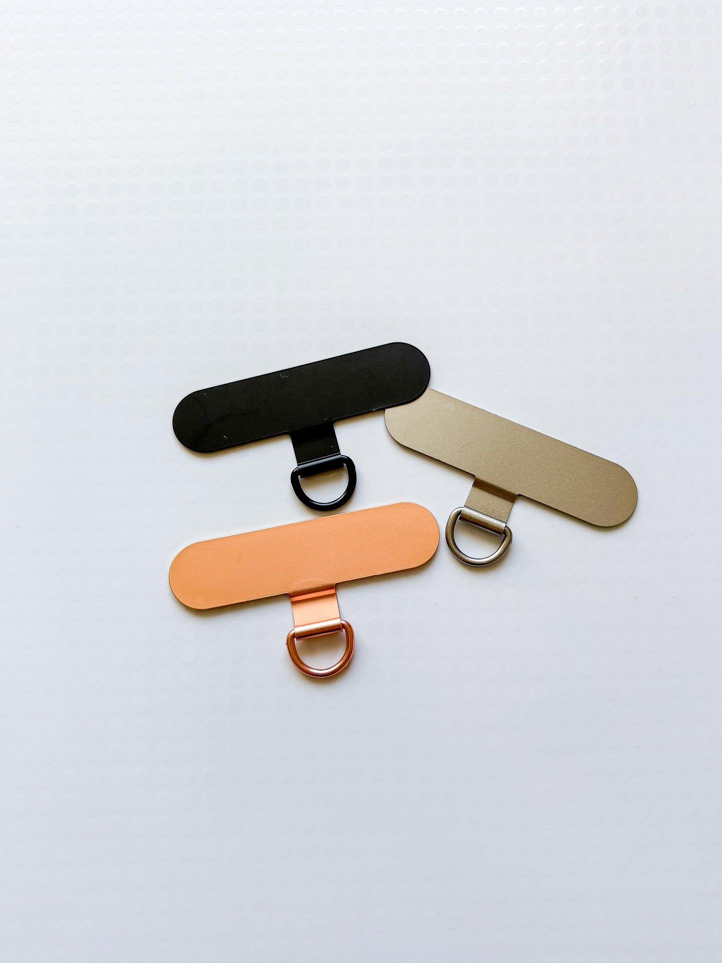 Držák na popruh na telefon (kovový/4 barvy)