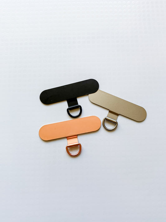 Držák na popruh na telefon (kovový/4 barvy)