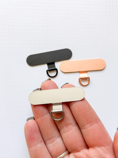 Držák na popruh na telefon (kovový/4 barvy)